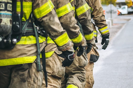 Firefighters walk in a line